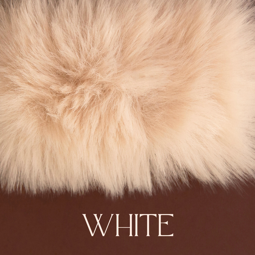 An ivory white faux fur blanket. 