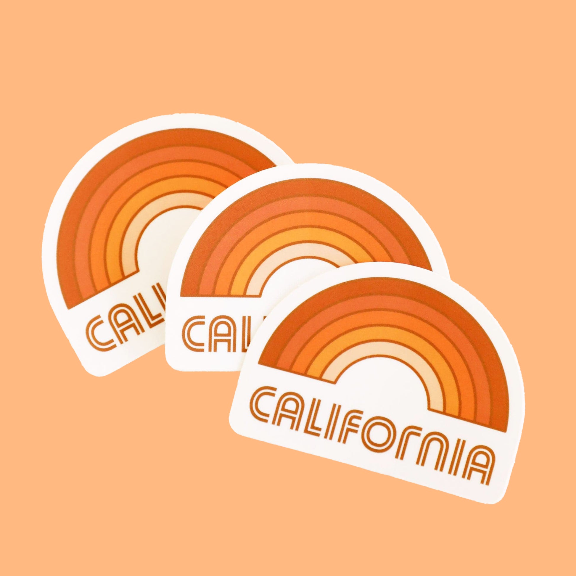 A rainbow sticker made up of different shades of orange and "California" written in orange letters on the bottom underneath the rainbow graphic.