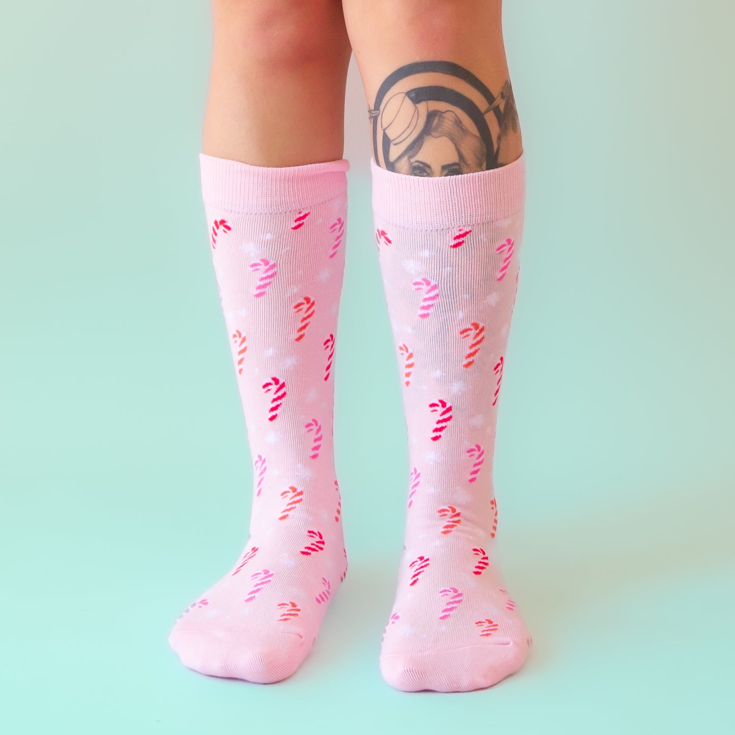 A pair of pink crew socks with a pink cotton candy pattern. 