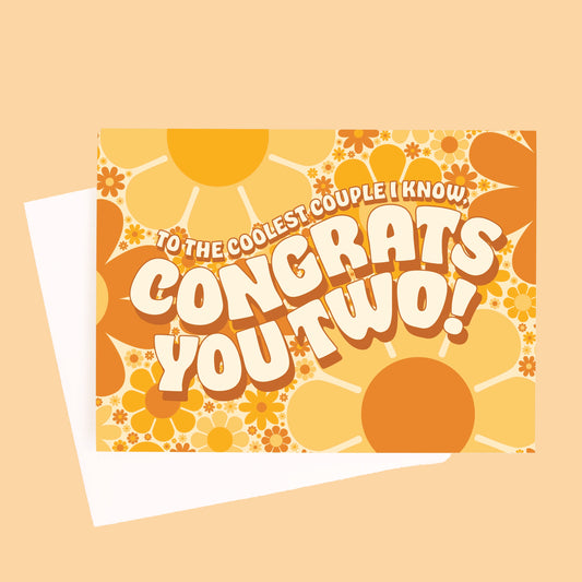 On a yellow background is a daisy print congratulations card with shades of orange and brown along with wavy text in the center that reads, "To The Coolest Couple I Know, Congrats You Two!".