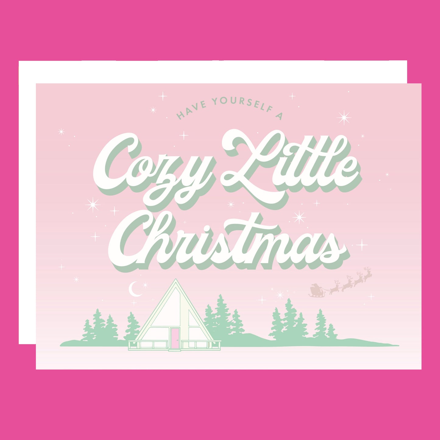A pink and mint green Christmas card with an A-frame graphic and text above that reads, "Have Yourself A Cozy Little Christmas".