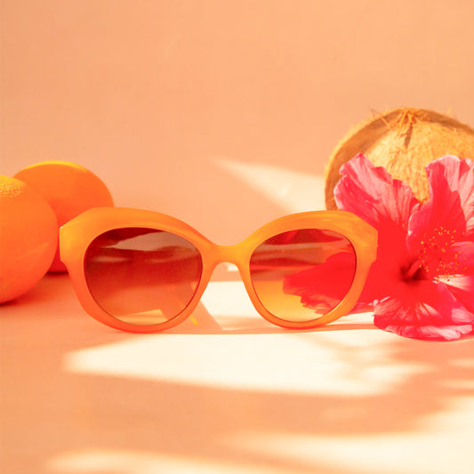 Chunky round orange sunglasses with a brown lens.