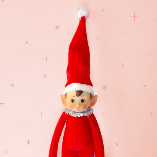 A red elf shaped ornament. 