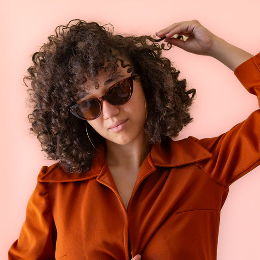 A brown tortoise print pair of cat-eye shaped sunglasses.