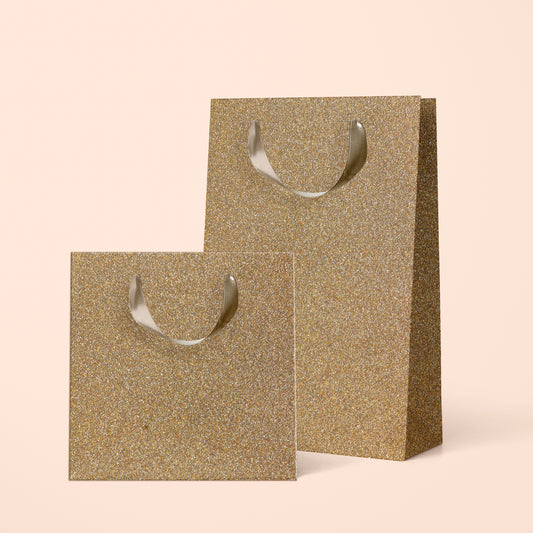 Two different sized gold sparkle gift bags. 