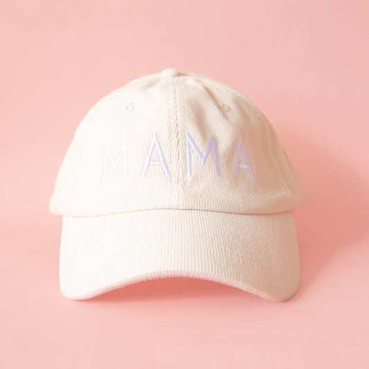 An ivory colored corduroy baseball hat with embroidered lettering that reads, "MAMA" in white across the front.