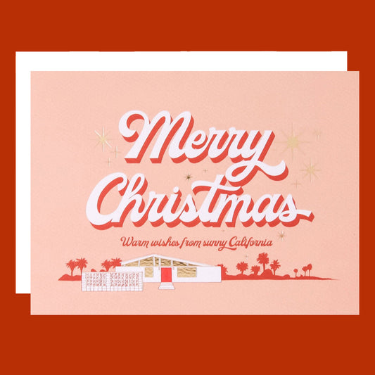 A peachy card with a graphic of a midcentury home and text that reads, 'Merry Christmas Warm wishes from sunny California'. 