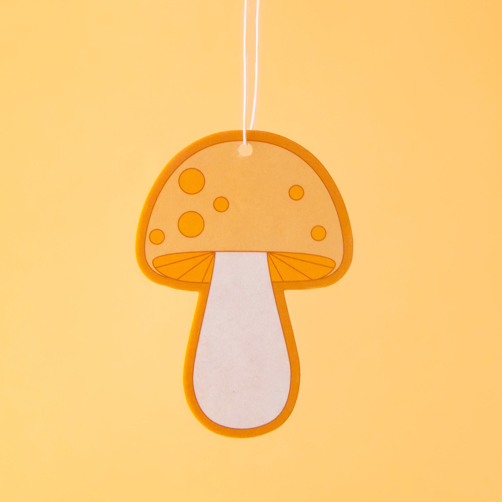 A yellow and orange mushroom shaped air freshener.