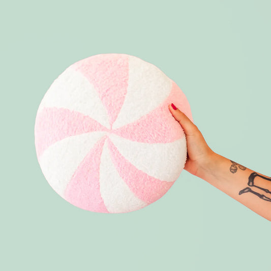 A light pink and white circle swirl pillow. 