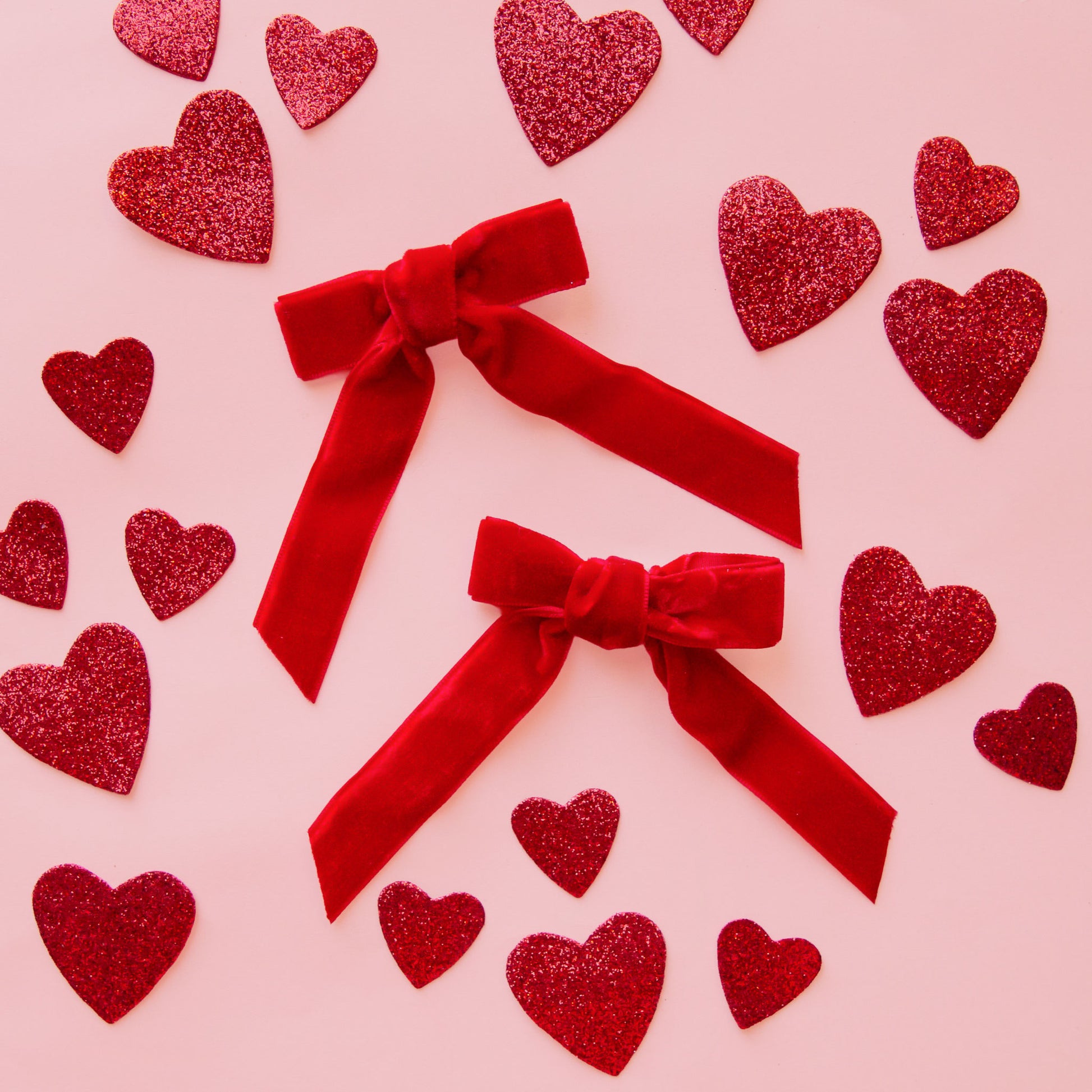 A set of red hair bows. 