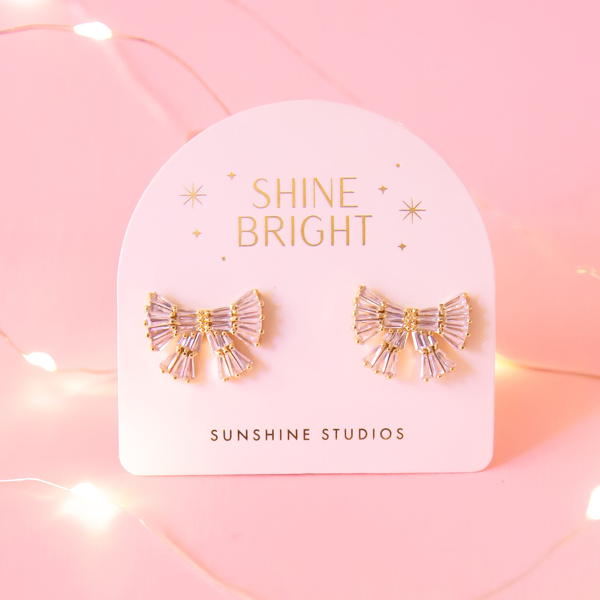CZ baguette bow earrings with gold detailing