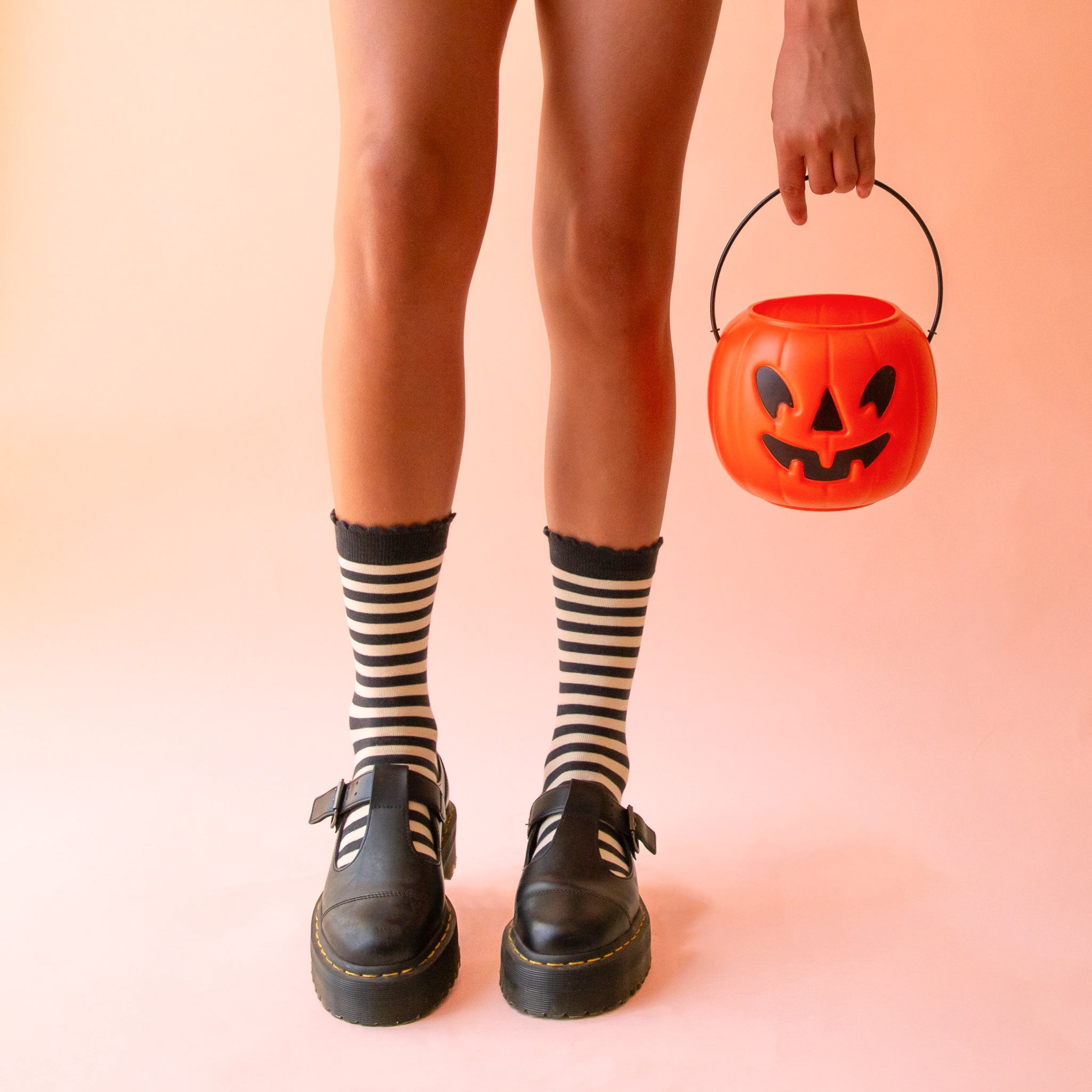 A pair of black and cream striped crew socks. 