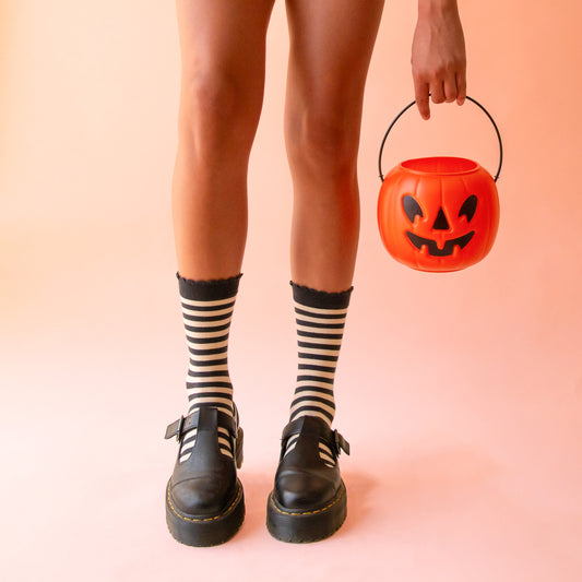 A pair of black and cream striped crew socks. 