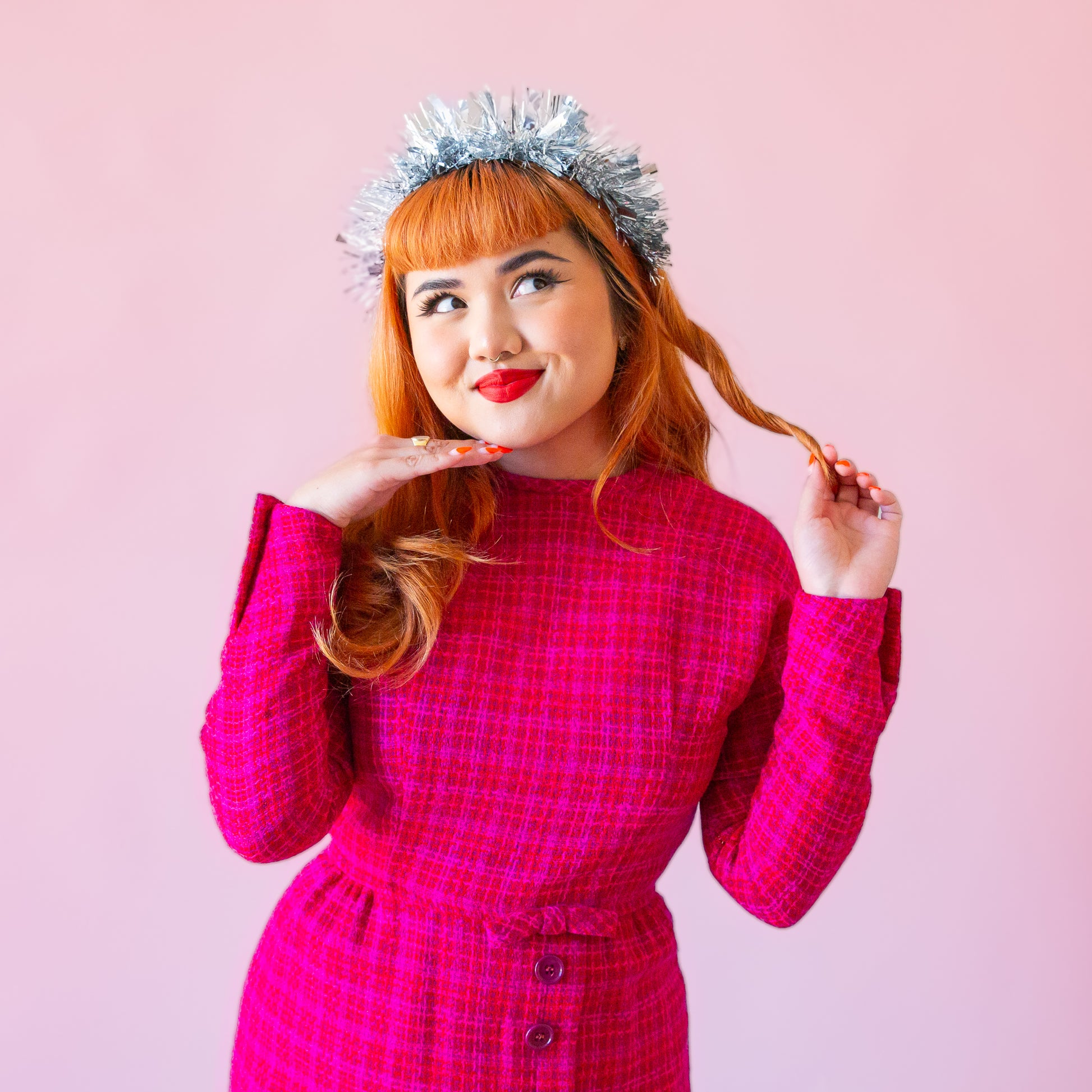 A model wearing a silver tinsel headband. 
