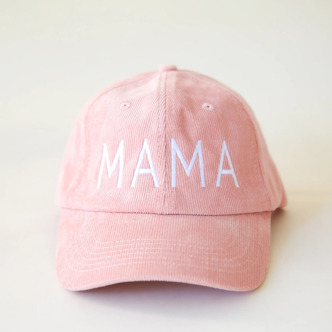 A pink corduroy baseball hat with embroidered lettering that reads, "MAMA" in white across the front.