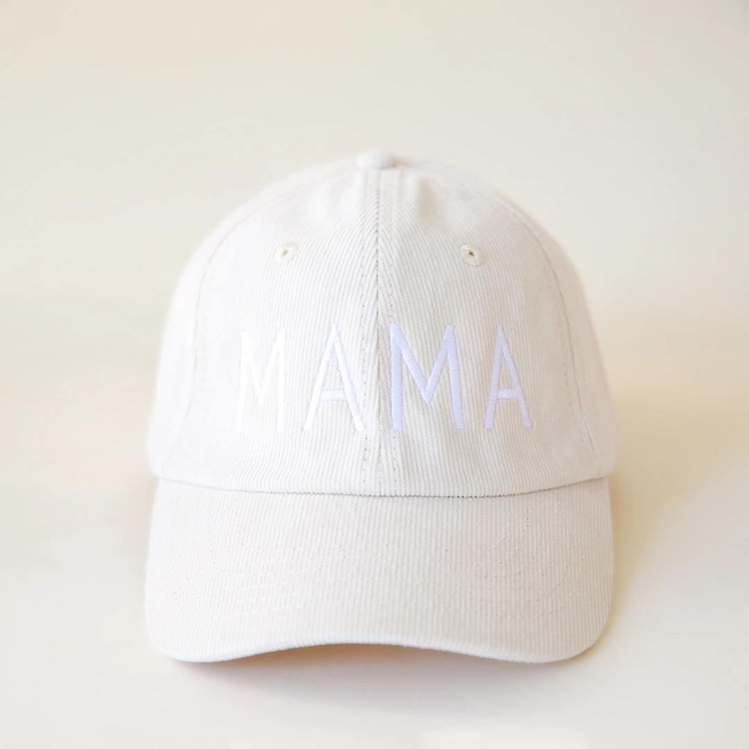 An ivory colored corduroy baseball hat with embroidered lettering that reads, "MAMA" in white across the front.