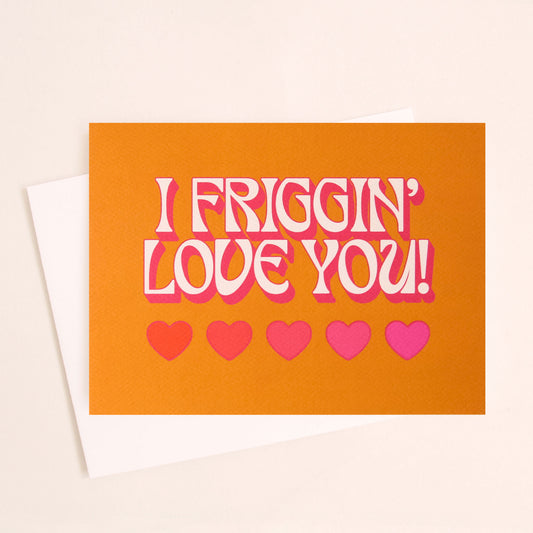 Burnt orange card that reads 'I friggin' love you!' in white text with a thin pink shadow. Below the text are five hearts in various shades of pink.
