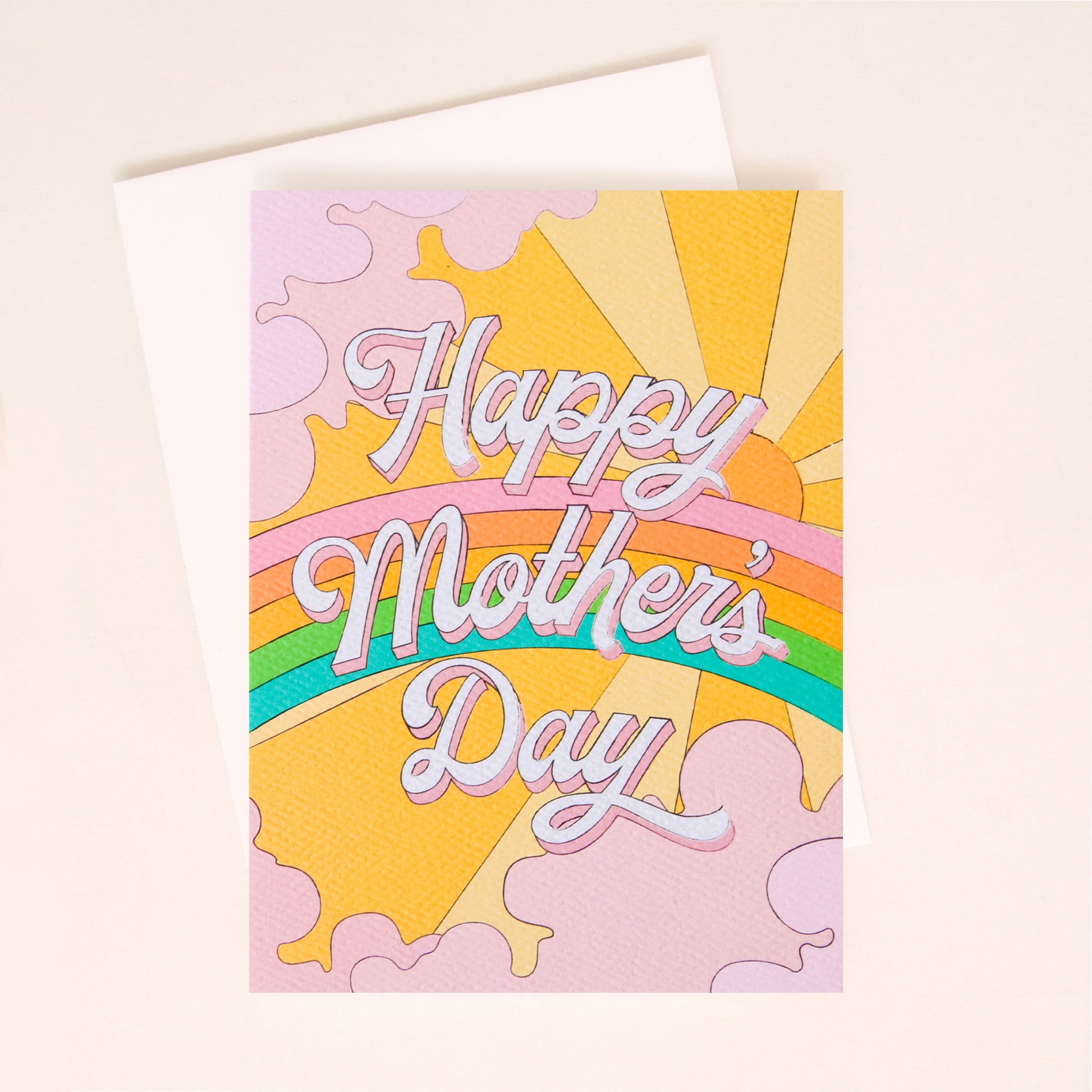 Card with a vibrant scene of a rainbow and beaming yellow sun. Soft lavender clouds take up the edges. The center of the card reads 'Love You Mom' in white cursive lettering with a pink shadow.