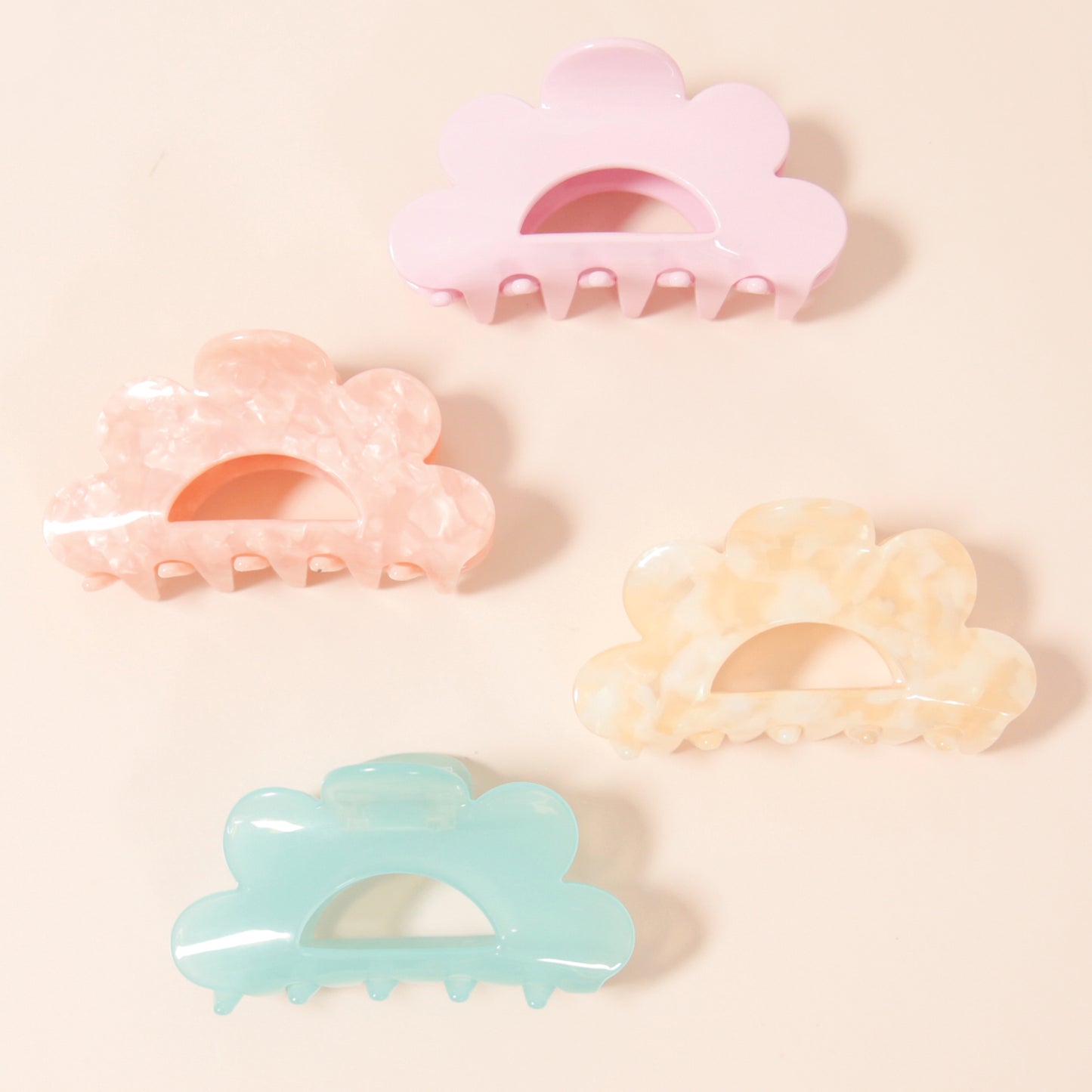 An aqua scalloped claw clip made of durable plastic.