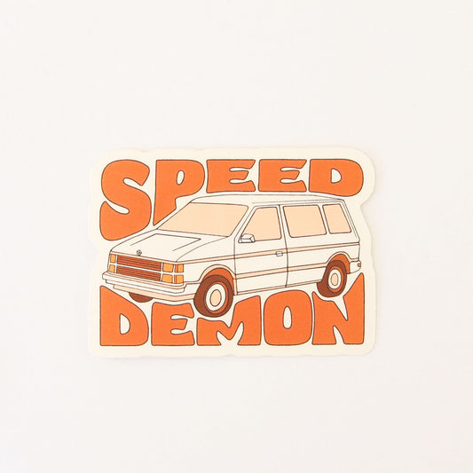 70s inspired sticker featuring an old school mini van. Wrapped around the van reads 'Speed Demon' in orange capital bubble lettering.