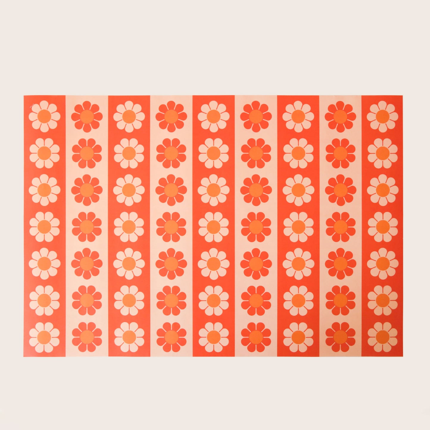 Sheet of wrapping paper filled with vertical stripes of bright and pastel orange flowers.