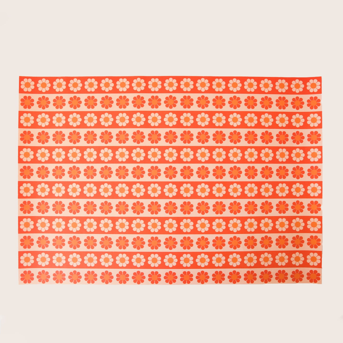 Sheet of wrapping paper filled with horizontal stripes of bright and pastel orange flowers.