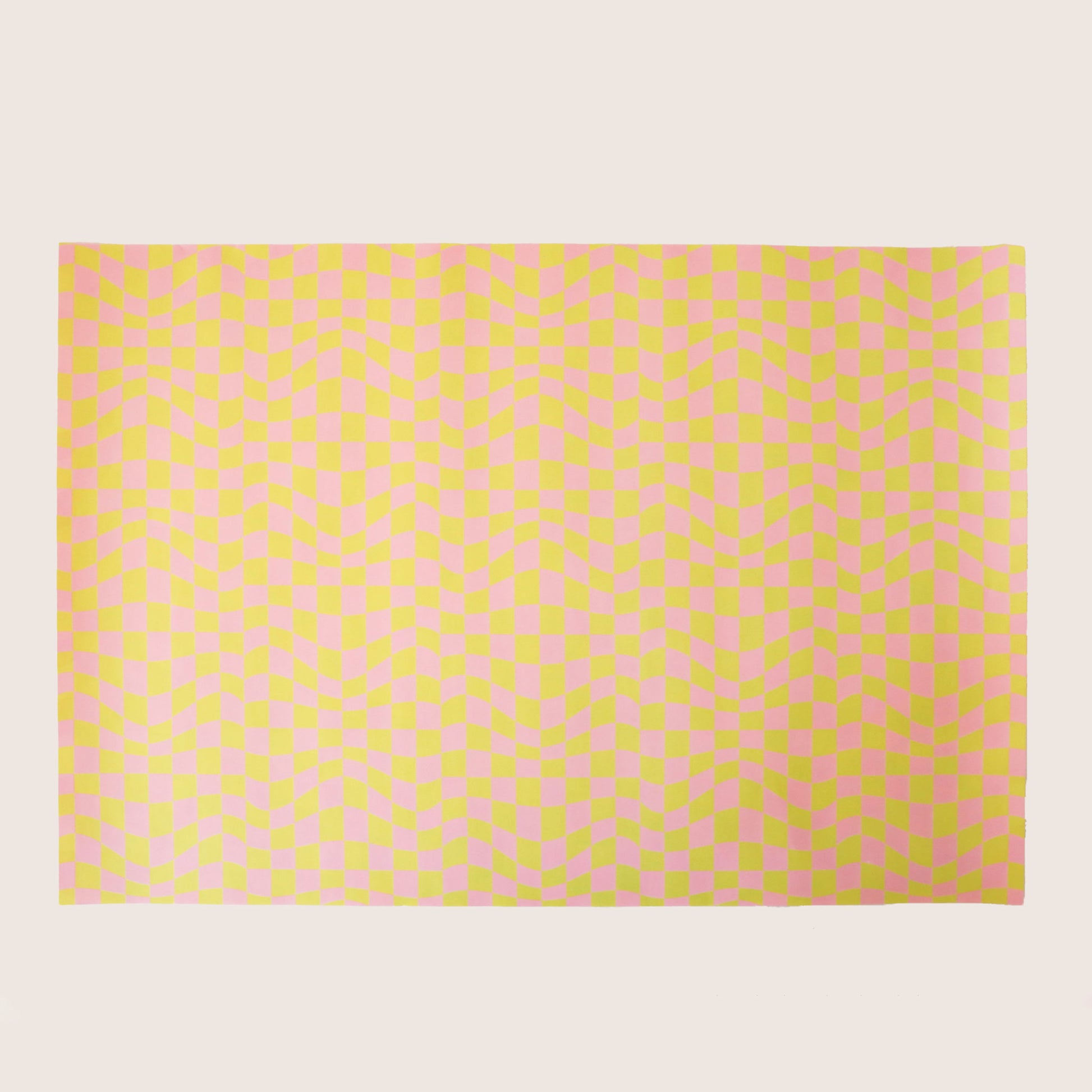 Sheet of distorted pink and yellow checkered wrapping paper.