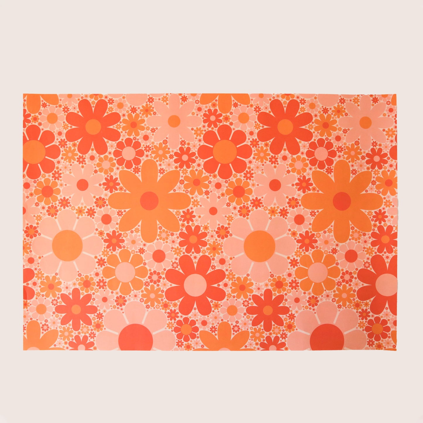 Sheet of wrapping paper filled with orange and pink flowers of various shapes and sizes.