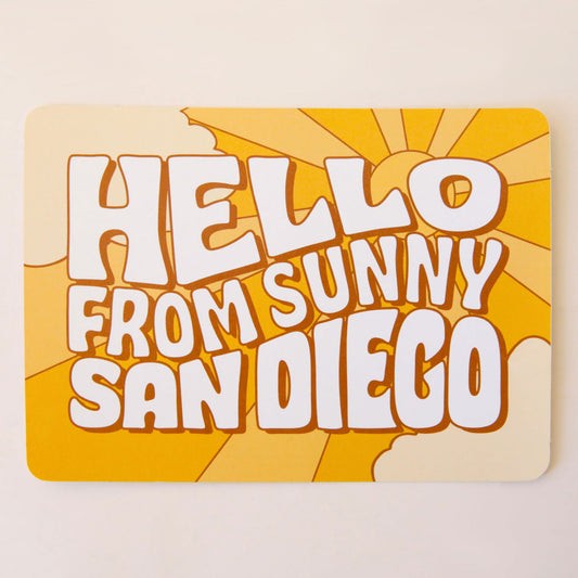 An orange postcard with 70's style text that reads, "Hello From Sunny California".