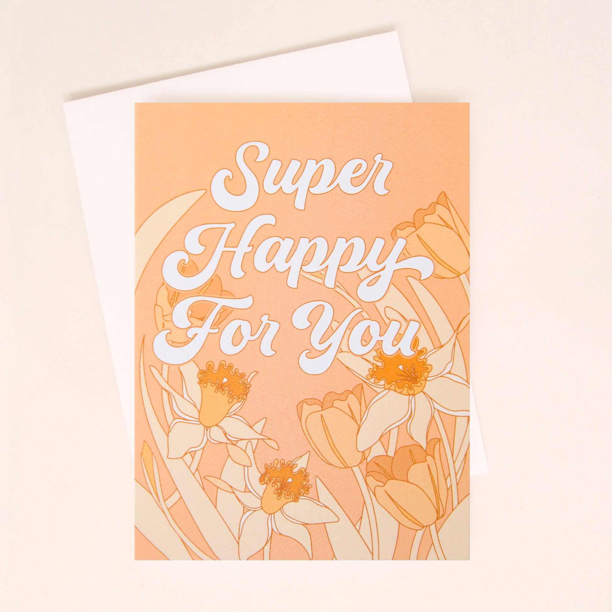 A peach colored card with a white envelope and white bubble cursive text that reads, "Super Happy For You" along with tulip and daffodil illustrations on lining the middle and bottom.