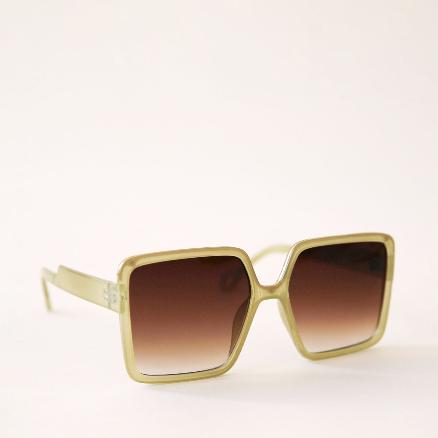 70's inspired square sunglasses with an olive green frame and a brown lens.