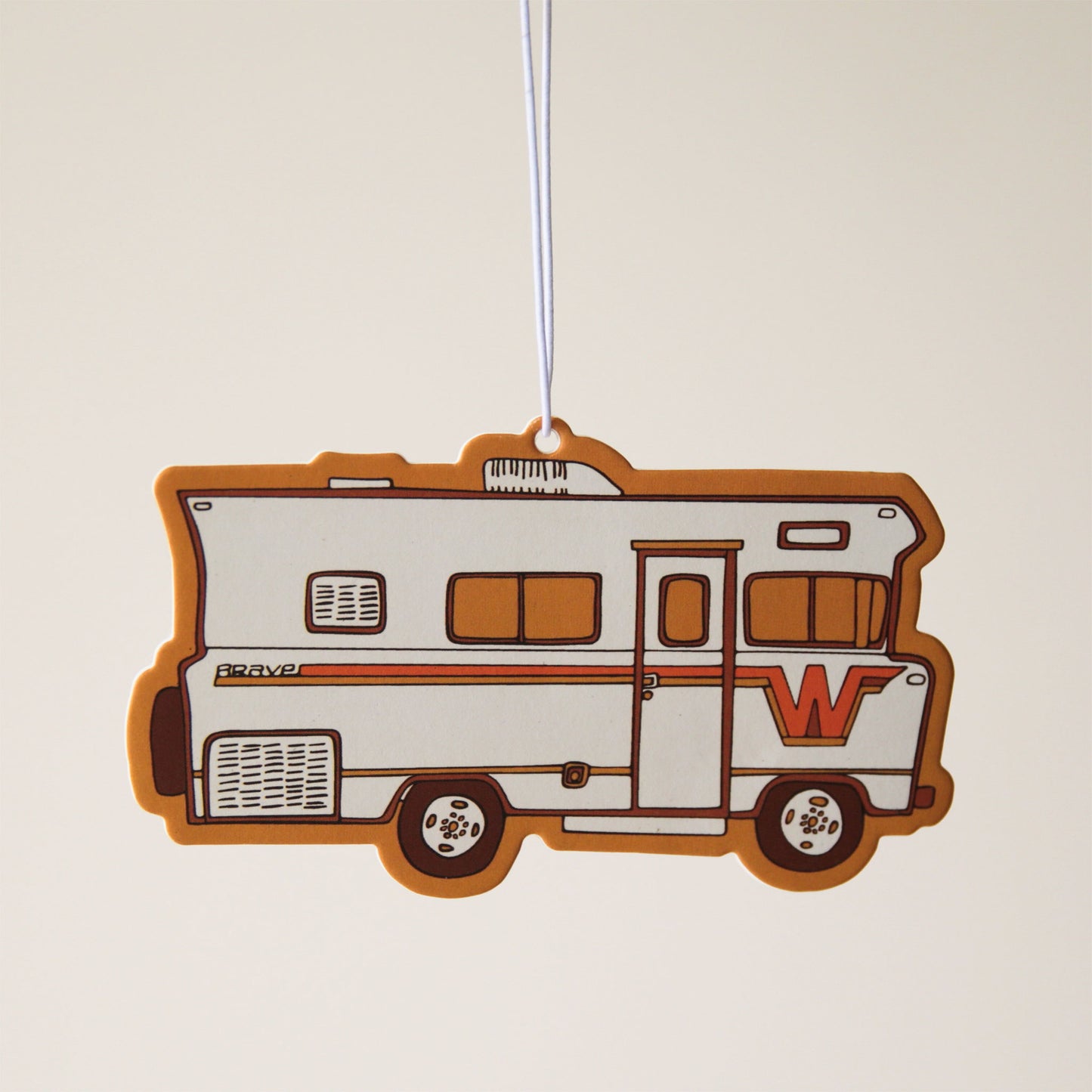 A vintage looking RV camper air freshener with red and orange accents.