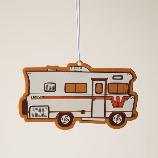 A vintage looking RV camper air freshener with red and orange accents.