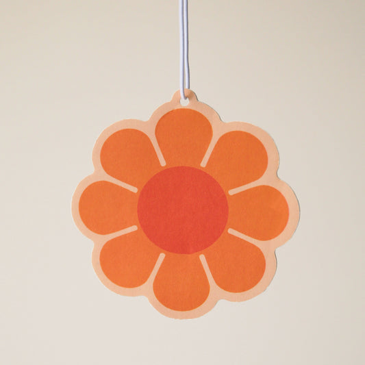 An orange 70's style daisy with a burnt red center.