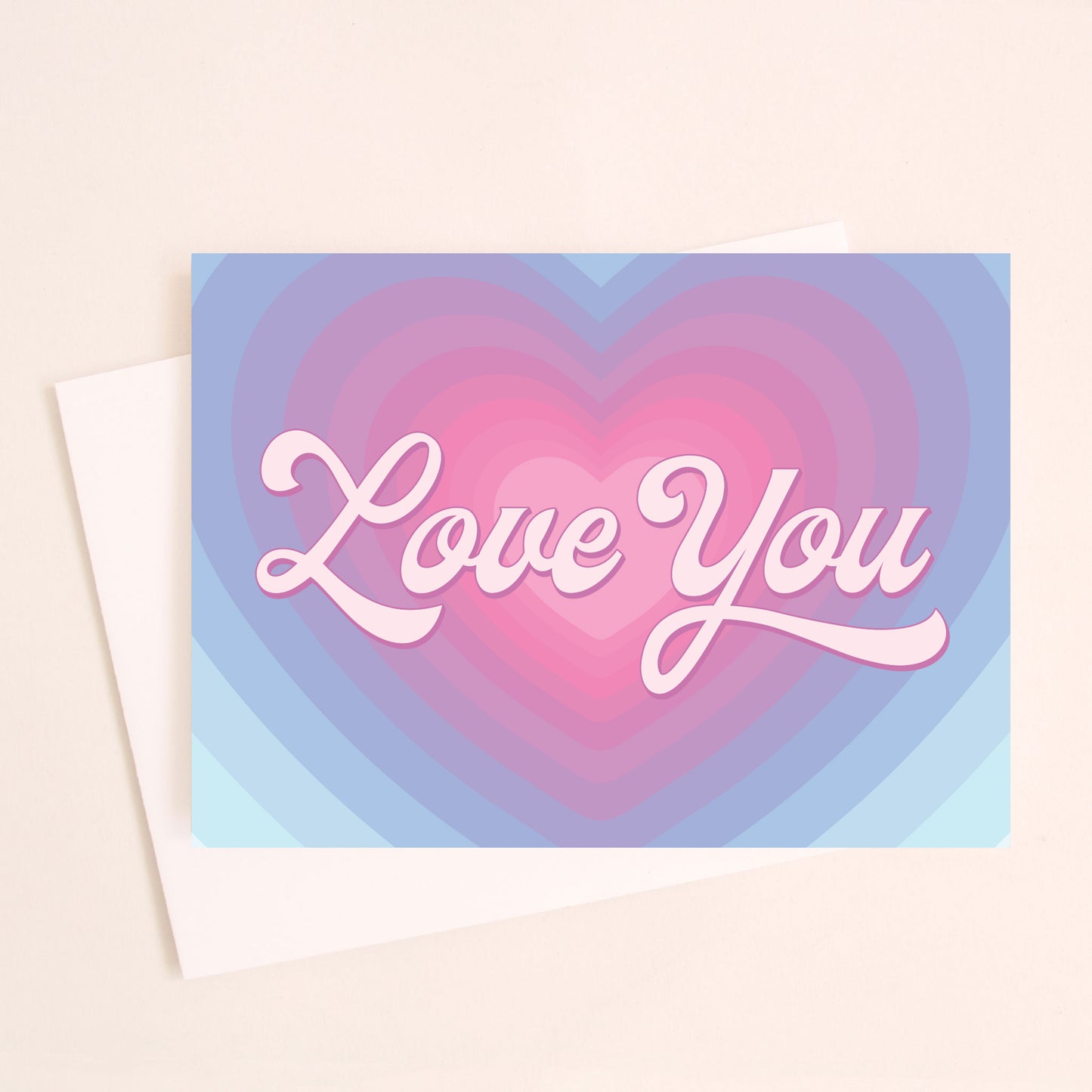A gradient heart design transitioning from light pinks to shades and purple and then shades of blue up until the edge of the card. In the center there is text that reads, "Love You". Also included is a coordinating white envelope.