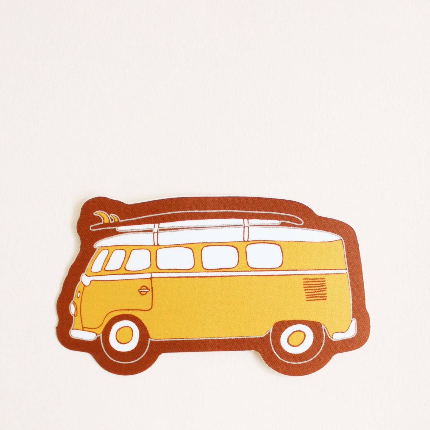 This vinyl sticker has a classic daffodil yellow VW Bug with a surfboard fastened on top, providing that classic beach cruiser vibe. The sticker has tawny brown bubble border