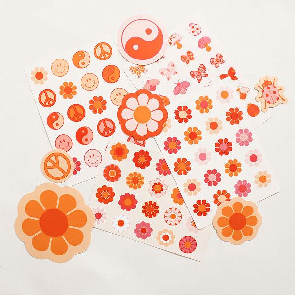 Four pages of sticker sheets filled with various 70 inspired designs including bus flowers, smiley faces, peace signs and more. Each sticker sheet has a vibrant orange, pink and red array of colors. A few larger stickers of flowers and yin yang signs lay across the sheets. 