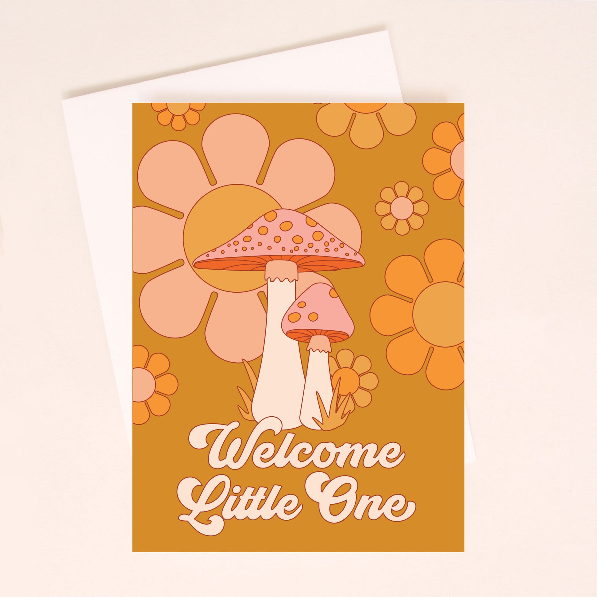 An orange card with two mushroom graphics in front of a daisy print and text that reads, "Welcome Little One" in cream letters.