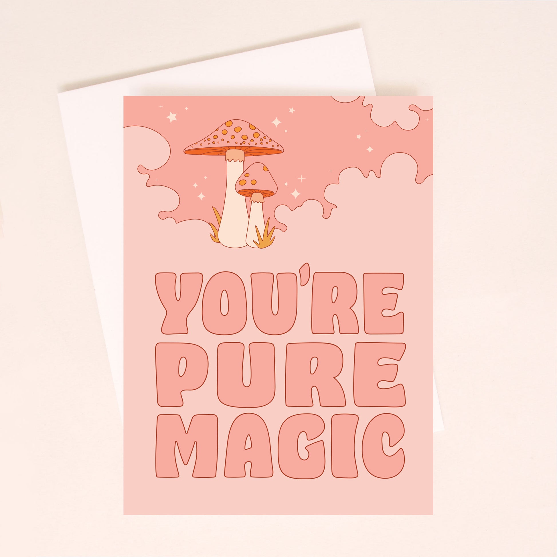 A pink card with cloud graphics and two mushrooms surrounded by dainty stars and text that reads, "You're Pure Magic" in big darker pink letters.